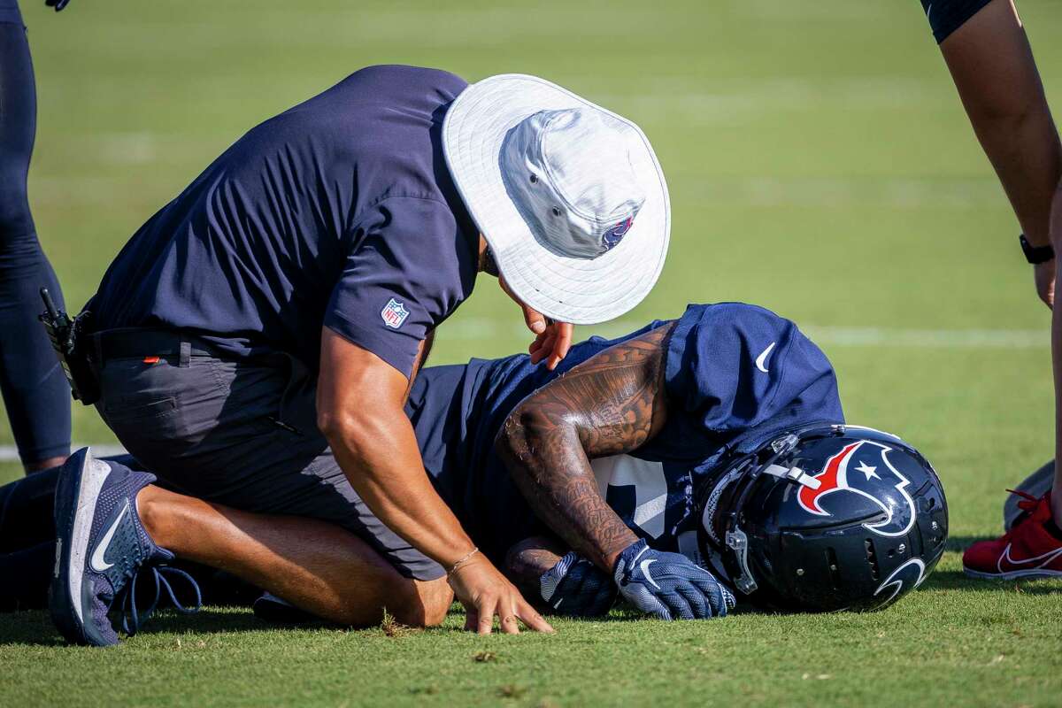 Staff attend wide receiver DaeSean Hamilton during a Texans practice on Monday, June 7, 2022.