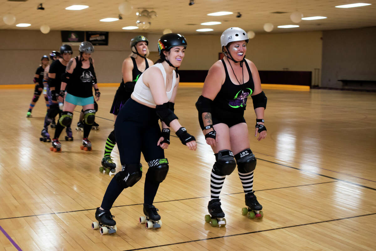 Madeline Morgan of Midland, or "Mad Hatter," left, and Candice Kanthe of Pinconning, or "CurVicious," right, skate with teammates as the Chemical City Derby Girls hold practice Monday, June 6, 2022 at the Roll Arena in Midland.