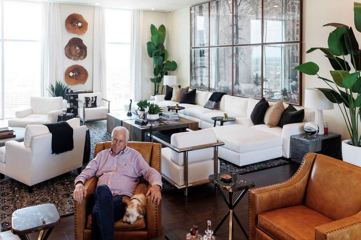 Charlie Amato, the 74-year-old chairman of the financial services firm SWBC, sits in his living room with his dog Lacy.