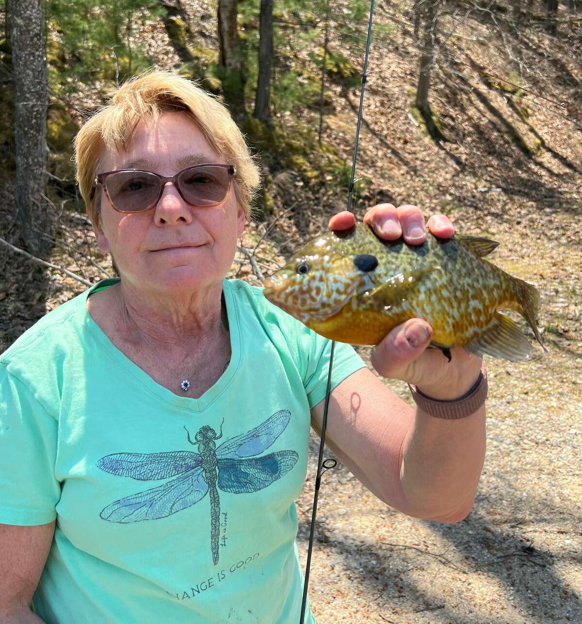 Kathy Songer, of Gladwin, shows a slab-sized bluegill that she caught from a private lake in Roscommon County. June is a prime month for bluegills and their kin, wherever they swim in Michigan.