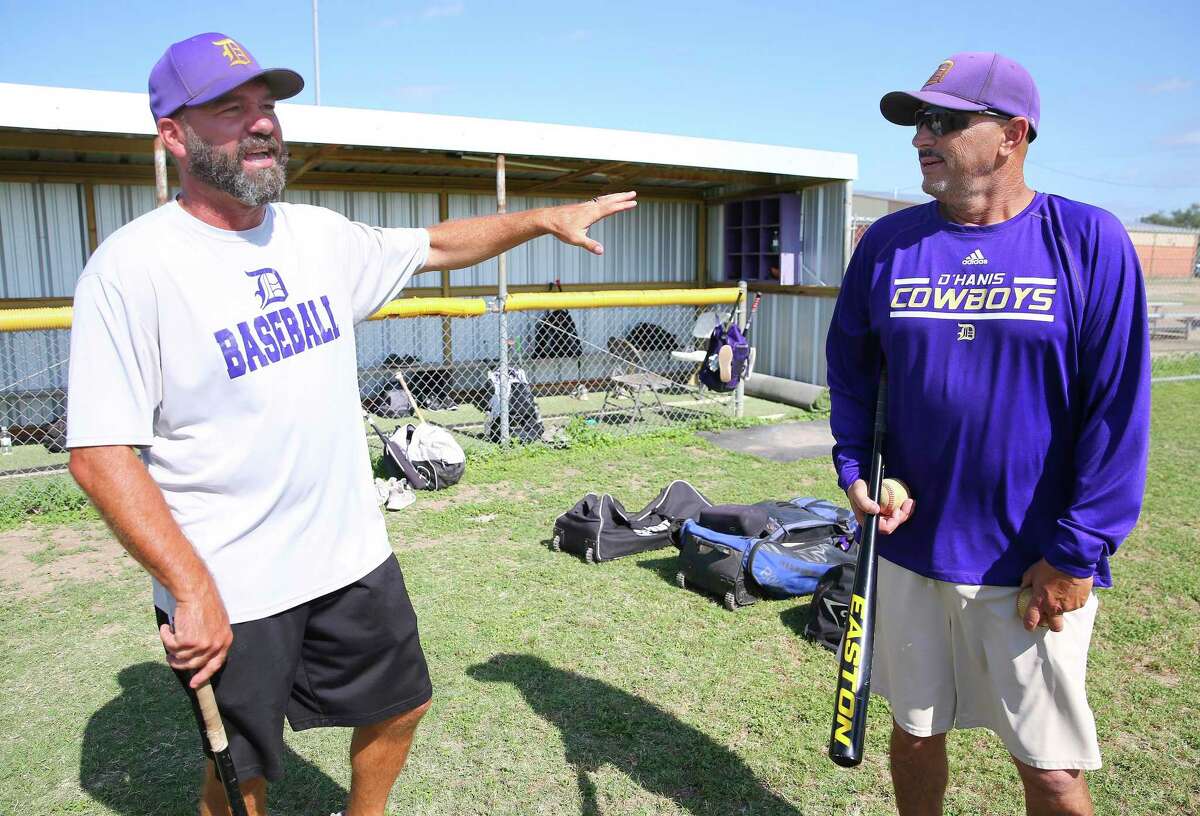D’Hanis baseball coach Todd Craft (left) and assistant coach Troy Langfeld conduct practice to prepare their team to play in the semifinal state championship game on Monday, June 6, 2022.
