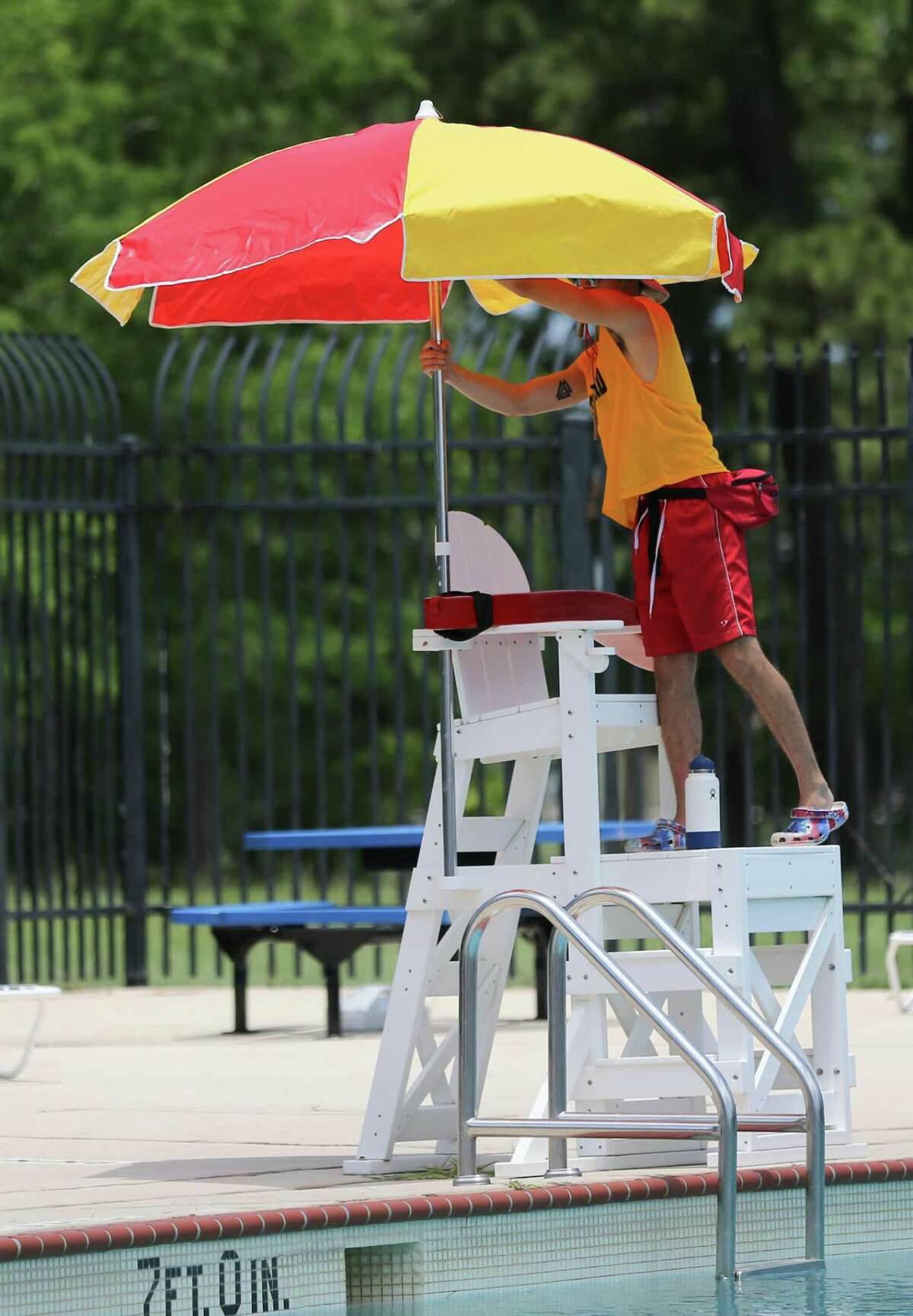 Nico Garza, 20, sets up his lifeguard stand at the Mason Park swim pool on Tuesday, June 7, 2022 in Houston. Garza has been lifeguarding with Houston for four years.