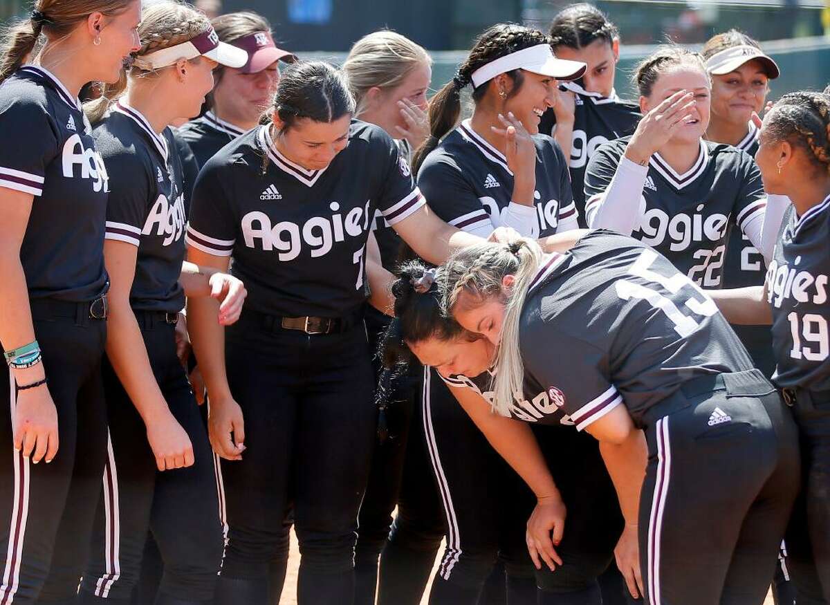 Texas A&M’s Kayla Poynter (6) places her cleats on home plate after losing a softball game to Oklahoma in the NCAA Norman Regional in Norman, Okla., Sunday, May 22, 2022.