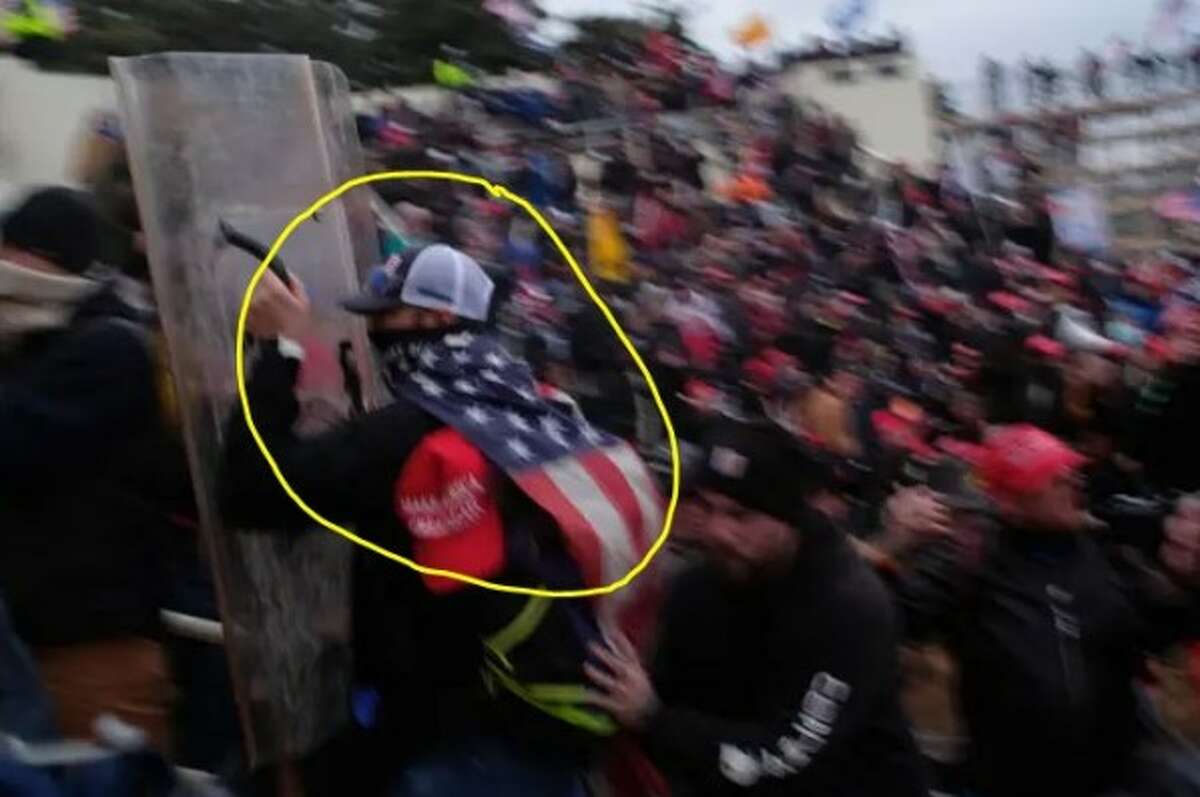 Andrew Jackson (circled in yellow) allegedly pictured rushing law enforcement officers with a riot shield during the Jan. 6, 2021, riot at the U.S. Capitol. 