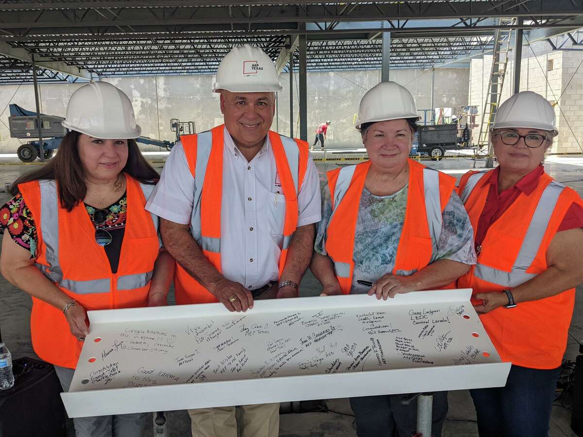 Tony Arce Jr. and others hold ceremonial steel beam. American Electric Power (AEP) Texas in Laredo held a “topping off” ceremony in conjunction with Cobalt Construction to mark the more than halfway construction of the new AEP Texas Service Center in Laredo that is slated to open early next year on Tuesday  June 7, 2022. 