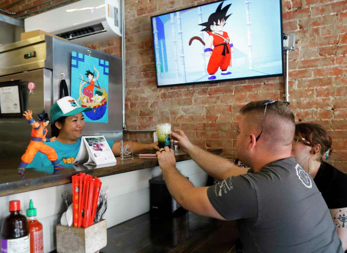 Kelly Cheng, co-owner of Dragon Bowl C, serves customers, Tuesday, June 7, 2022, in Conroe. The restaurant is located between The Corner Pub and Shepherd's Barbeshop on Simonton Street. San Cheng and his family also owns Taste the Asian food truck which is at The Table at Madeley.