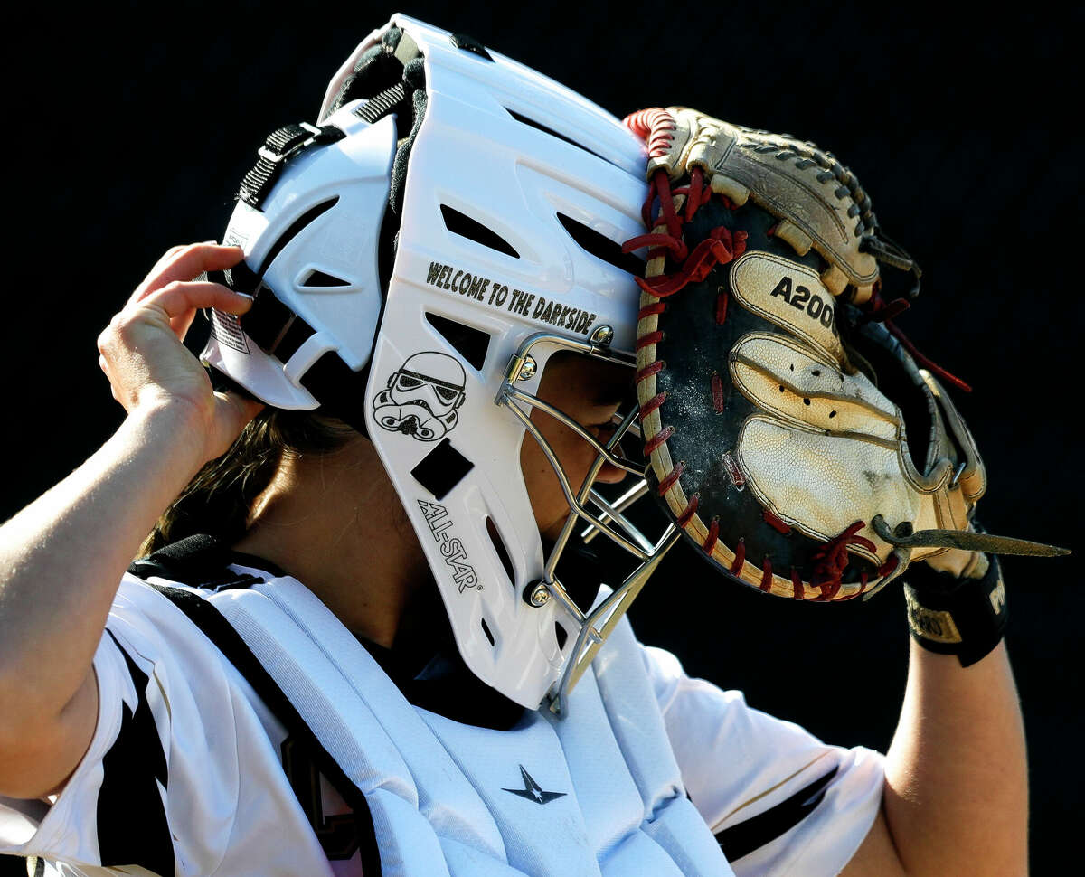 Conroe catcher Addison Fuller (26) puts on her equipment in the first inning during a District 13-6A high school softball game at Conroe High School, Wednesday, March 23, 2022, in Conroe.