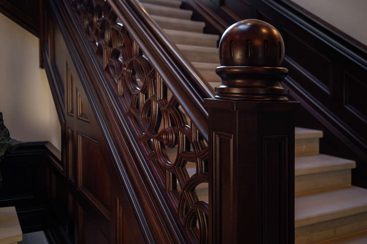 An elaborate wood-carved banister.