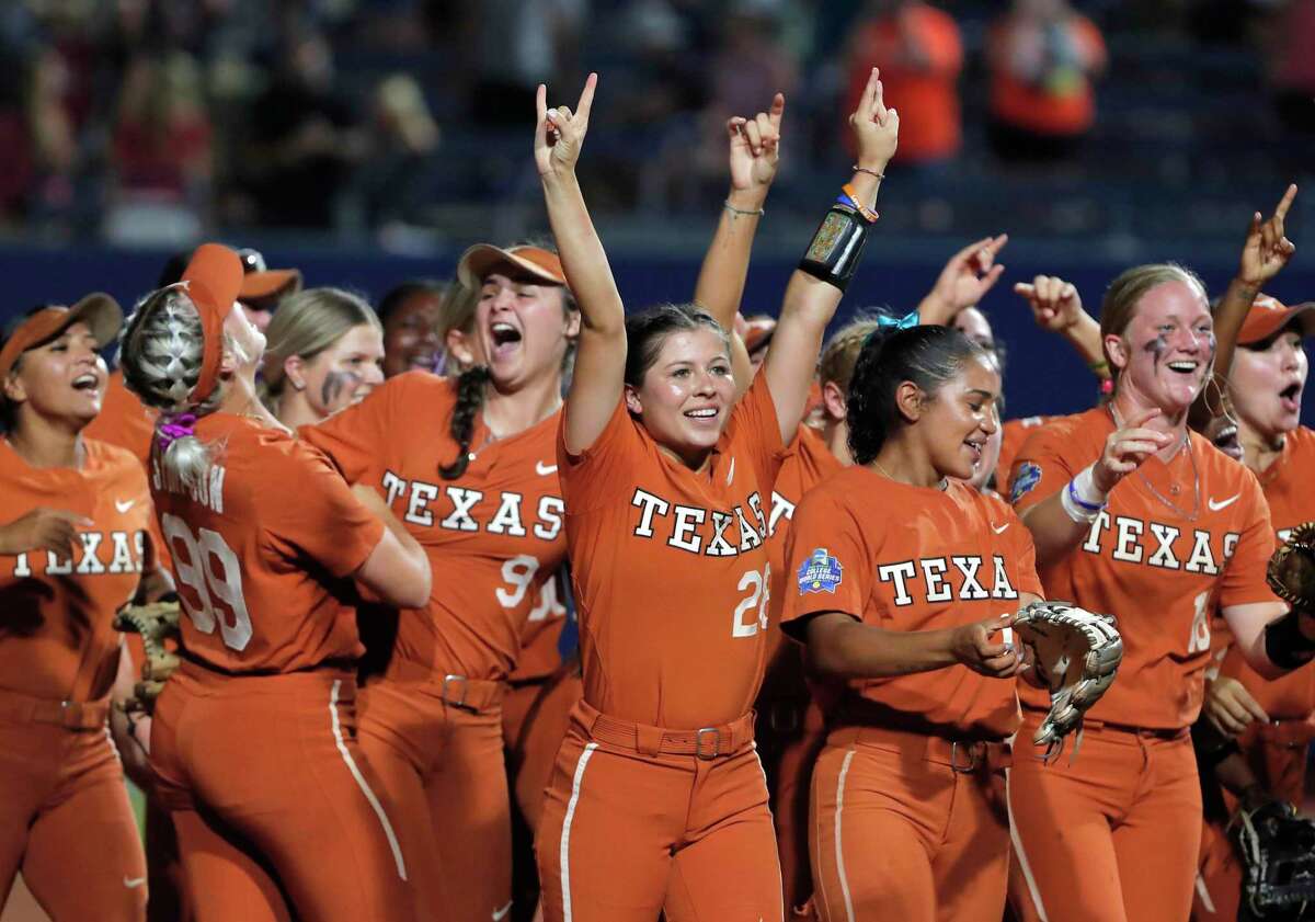 Texas players celebrate after knocking off Oklahoma State in the WCWS semifinals on Monday night in Oklahoma City.