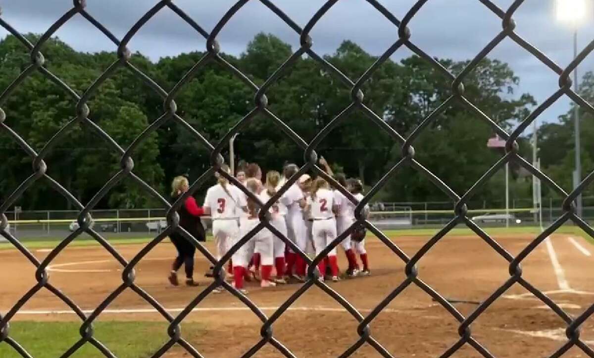 Members of the Cromwell softball team celebrate after defeating Old Lyme 3-1 in the CIAC Class S tournament in West Haven Tuesday.