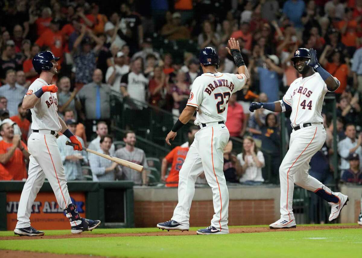 Houston Astros Yordan Alvarez (44) celebrates his two-run home run with Michael Brantley which was challenged as a fan interference during the eighth inning of a MLB game at Minute Maid Park on Tuesday, June 7, 2022 in Houston.