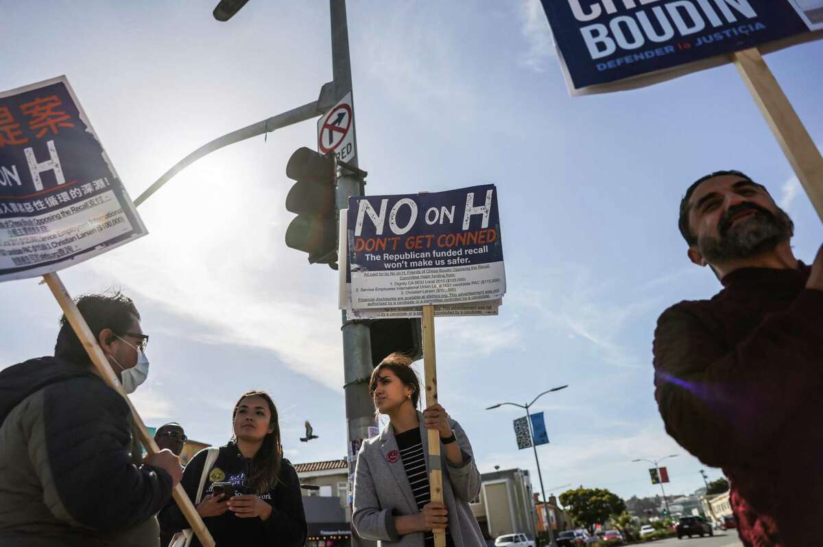 Chesa Boudin supporters Jessica Montes (center) and Luis Avalos (left) canvass in the Mission ahead of the recall on Tuesday, June 7, 2022 in San Francisco, California.