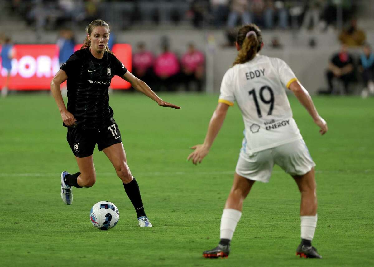LOS ANGELES, CALIFORNIA - JUNE 07: Dani Weatherholt #17 of Angel City FC controls the ball in front of Elizabeth Eddy #19 of the Houston Dash during the second half in a 0-0 draw at Banc of California Stadium on June 07, 2022 in Los Angeles, California.