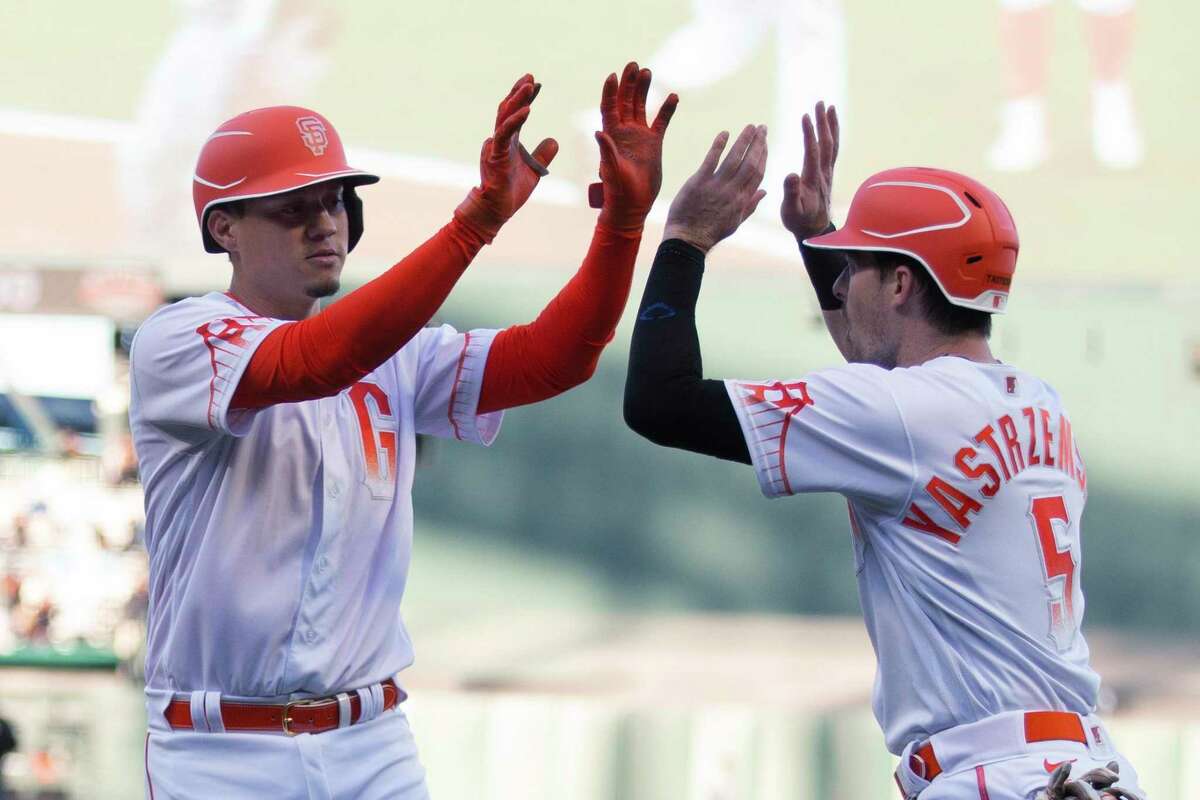 San Francisco Giants' Wilmer Flores and Mike Yastrzemski (5) celebrate Flores' two-run home run against the Colorado Rockies during the first inning of a baseball game Tuesday, June 7, 2022, in San Francisco. (AP Photo/D. Ross Cameron)