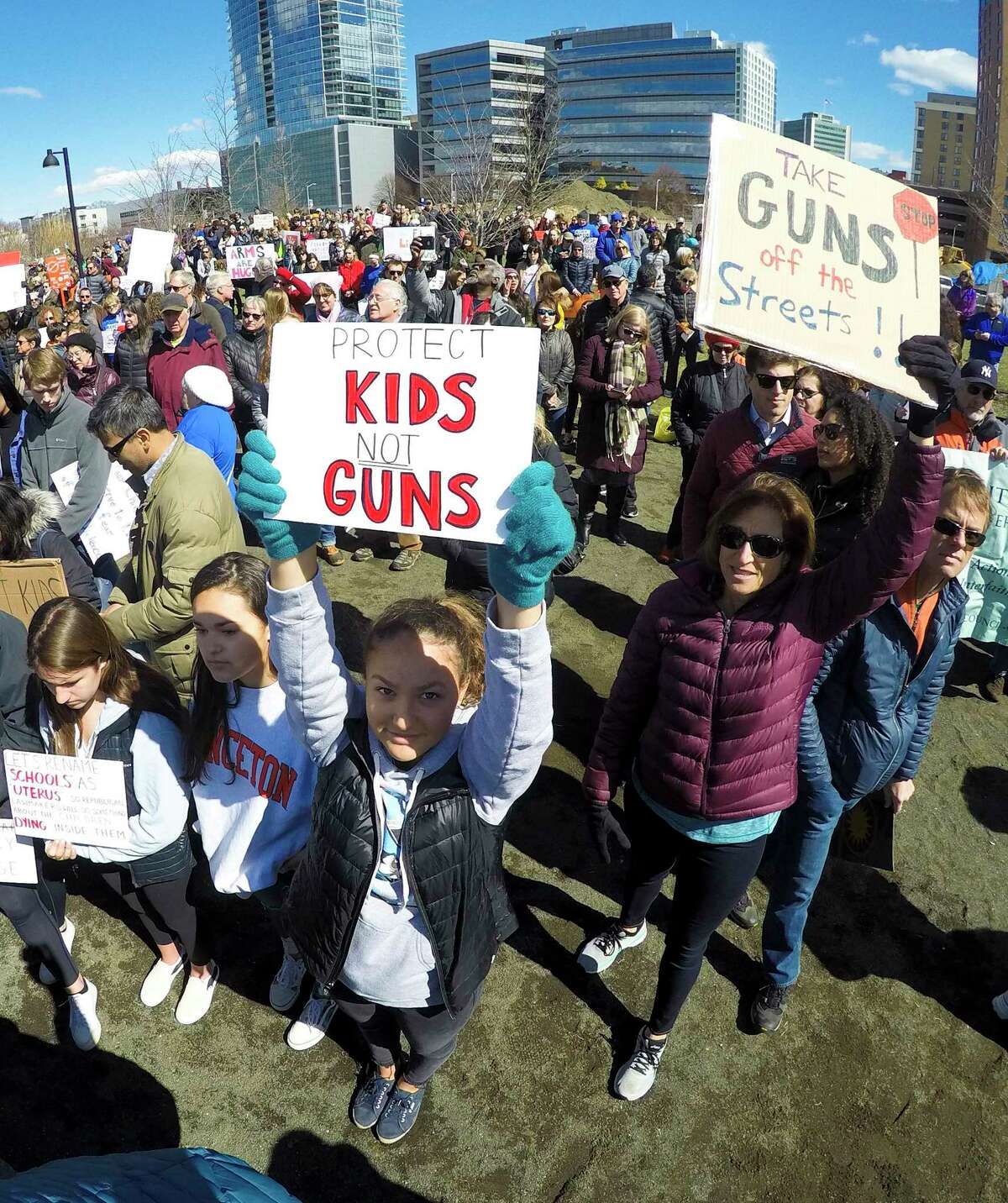 Ali Jaquiery of Westport holds a sign “Protect Kids, Not Guns” as she joins the estimated 2,000 Fairfield County residents who gathered to listen to student speakers at the March For Our Lives rally at Mill River Park on March 24, 2018 in Stamford. Conn.