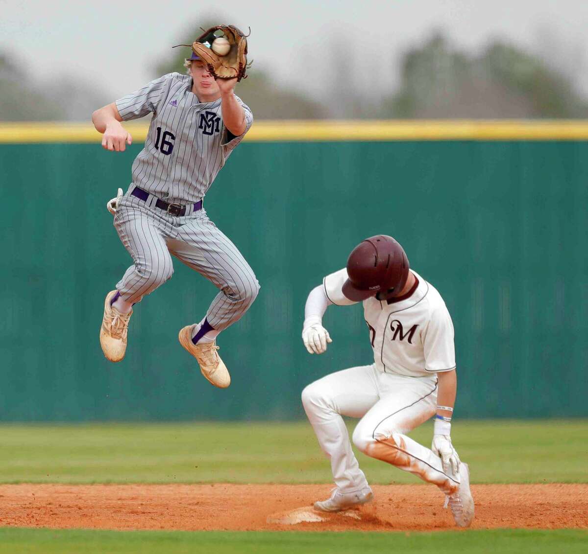 Montgomery shortstop Connor Benge (16) makes a leaping catch as Blake Casey #7 of Magnolia steals second in the fourth inning of a high school baseball game during the Brenham/Montgomery Tournament, Friday, March 4, 2022, in Montgomery.