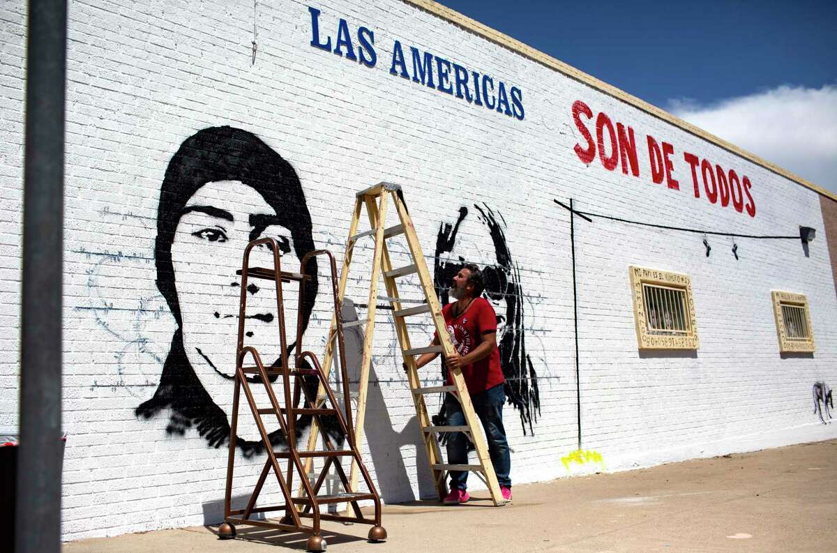 Manuel Oliver, father of Marjory Stoneman Douglas High School student Joaquin Olivera, moves a ladder to continue painting a mural in honor of his son in El Paso at the Las Americas Immigrant Advocacy Center on Sunday, Aug. 4, 2019.
