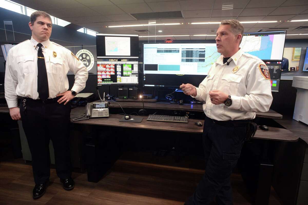 Assistant Fairfield Fire Chief Eric Kalapir, right, and Assistant Westport Fire Chief Mathew Cohen speak during a tour of the new Regional Dispatch Center, located on the campus of Sacred Heart University, in Fairfield, Conn. Feb. 28, 2022.