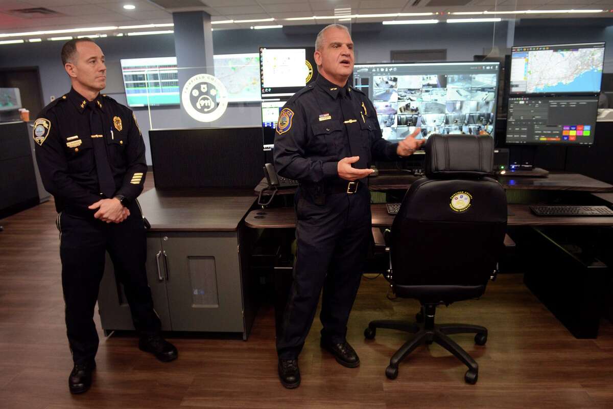 Westport Police Chief Foti Koskinas, right, and Fairfield Police Chief Robert Kalamaras speak during a tour of the new Regional Dispatch Center, located on the campus of Sacred Heart University, in Fairfield, Conn. Feb. 28, 2022.