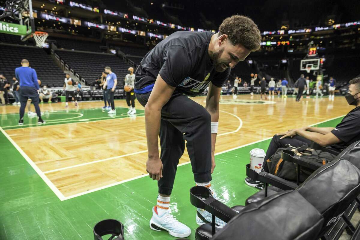 Klay Thompson (11) ties his shoes as the Golden State Warriors practiced the day before playing the Boston Celtics in Game 3 of the NBA Finals at TD Garden in Boston, Mass., on Tuesday, June 7, 2022.