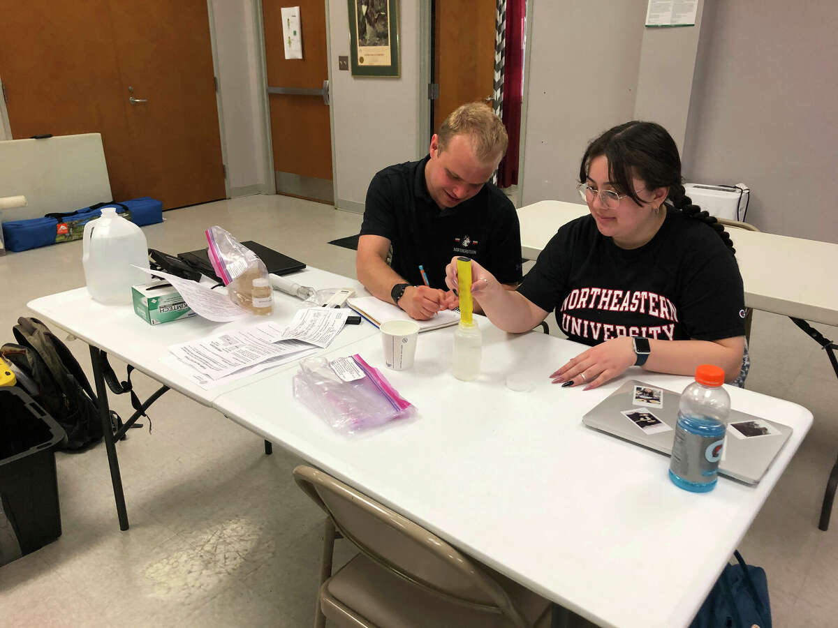 Students Wesley Hayes (left) and Lori Parker of Northeastern University process water samples while taking part in a testing program in Warren County, Mississippi. The program tests water provided by well owners for evidence of E. coli and other contaminants.