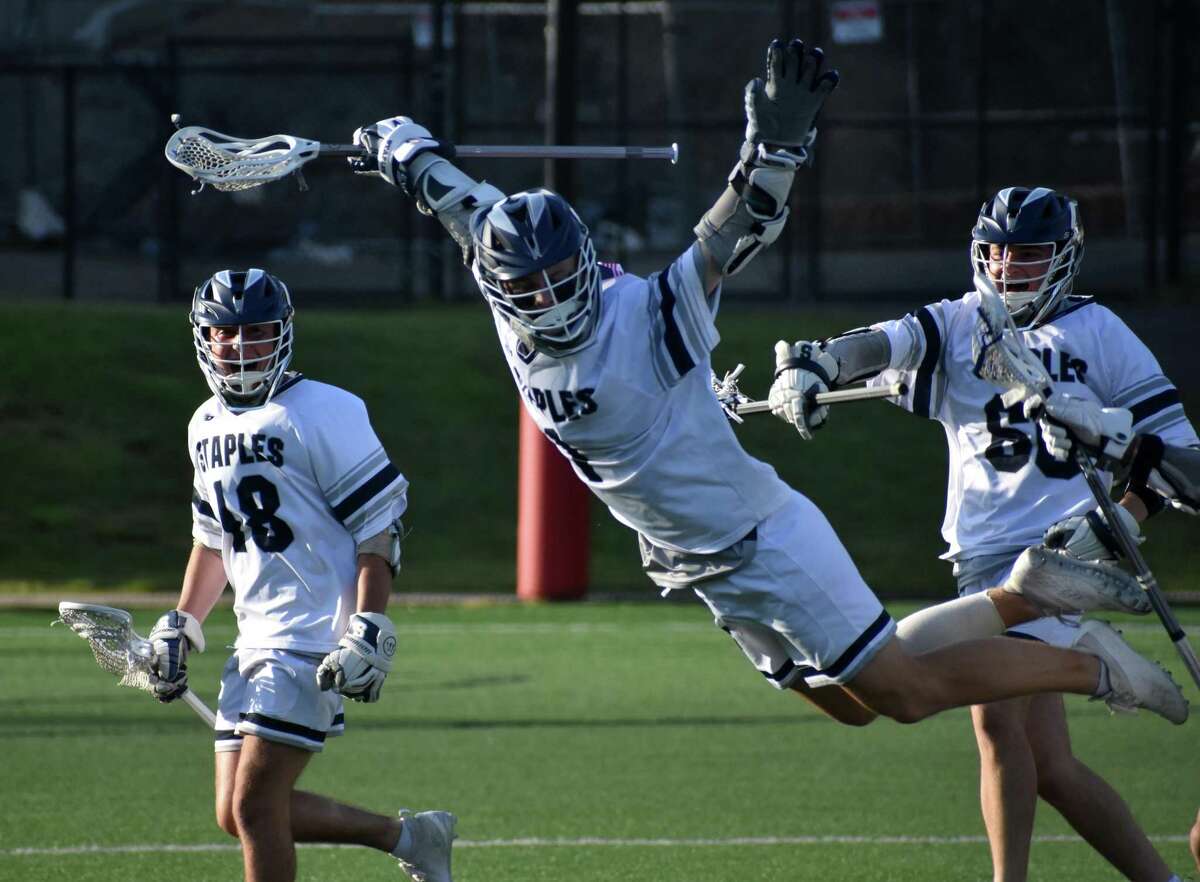 Staples’ Tyler Clark celebrates after scoring the winning goal in Staples’ 9-8 overtime win over Ridgefield in the Class L boys lacrosse semifinals at Rafferty Stadium Wednesday in Fairfield.