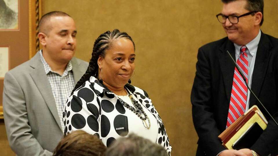 Sheba Muharib, with Aable Bonds, second from left, answers questions during the Harris County Bail Bond Board meeting Wednesday, April 13, 2022, in Houston. Her company had a request for renewal of license before the board. The board voted on a proposal to set minimum 10 percent fee on bail bonds.