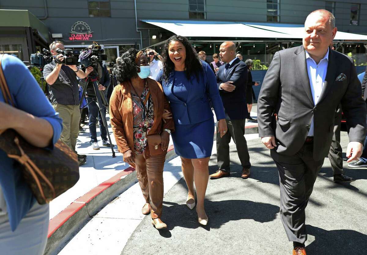 Mayor London Breed (center) walks with longtime friend Gwen Young after discussing economic recovery during an event in the design district.