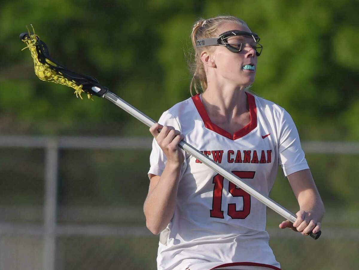 New Canaan’s Caitlin Tully in action against Darien in the FCIAC girls lacrosse championship game in Norwalk on Wednesday, May 25, 2022.