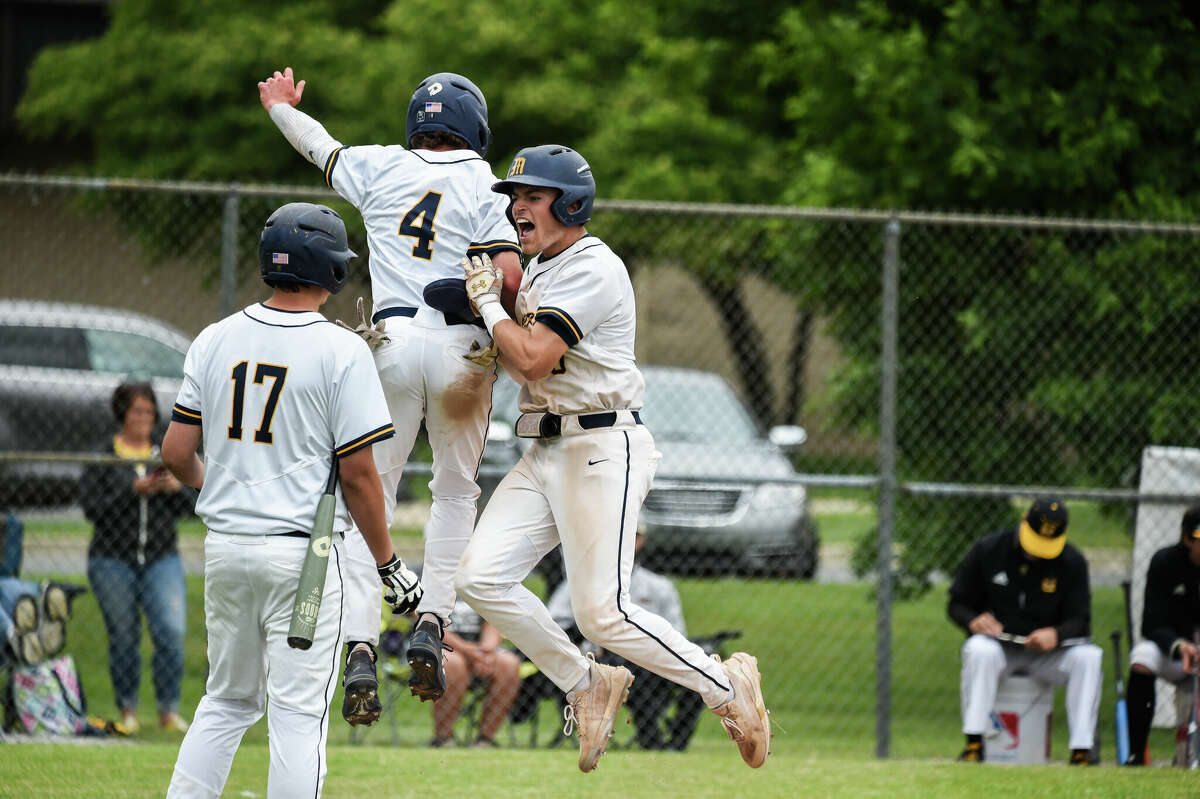 Chemics celebrate a run scored during Midland High's Division 1 regional semi-final win against Traverse City Central on June 8th, 2022 hosted by Saginaw-Heritage High School