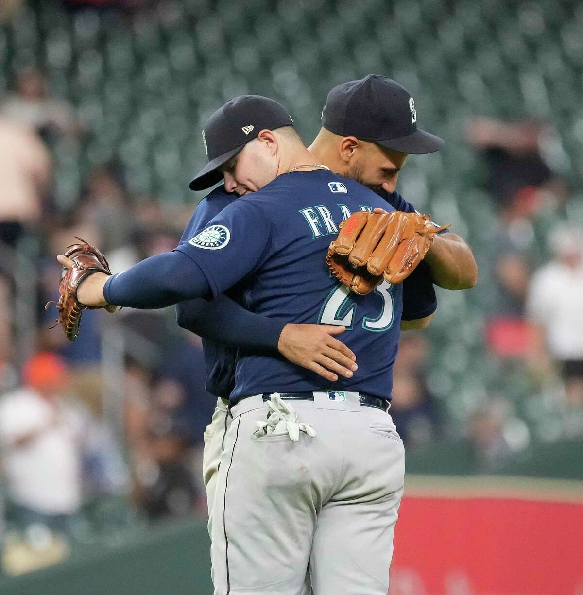 Seattle Mariners third baseman Abraham Toro (13) hugs Seattle Mariners first baseman Ty France (23) as they celebrate beating the Houston Astros 6-3 after a MLB game at Minute Maid Park on Wednesday, June 8, 2022 in Houston.