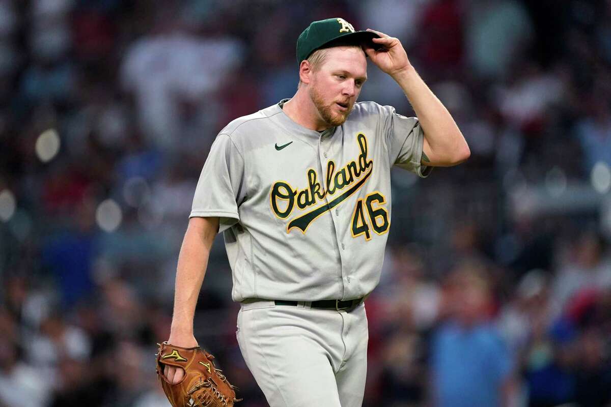 Oakland Athletics pitcher Jared Koenig adjusts his cap as he leaves the field after being removed during the fifth inning of the team's baseball game against the Atlanta Braves on Wednesday, June 8, 2022, in Atlanta. (AP Photo/John Bazemore)