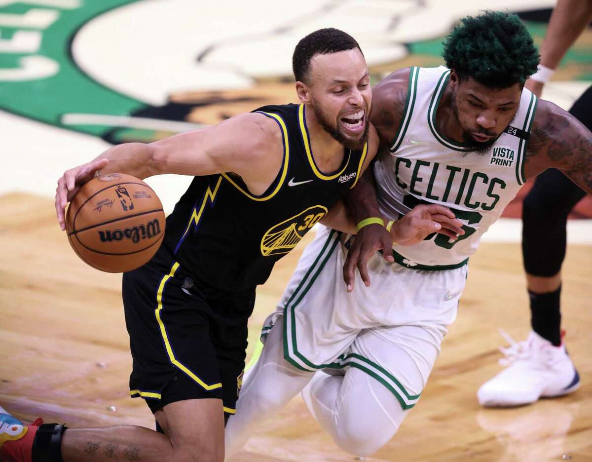 Golden State Warriors' Stephen Curry, 30, tries to get past Boston Celtics' Marcus Smart, 36, during the fourth quarter of the NBA Finals at TD Garden in Boston, Mass., on Wednesday, June 8, 2022.