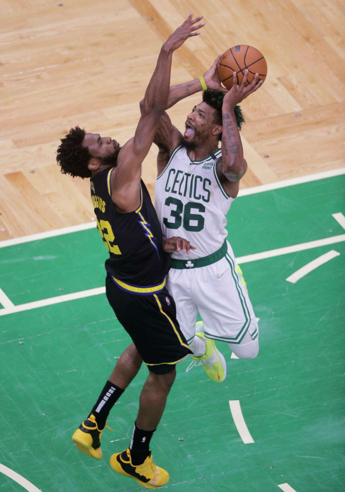 Boston Celtics' Marcus Smart, 36, goes up against Golden State Warriors' Andrew Wiggins, 22, during the third quarter of the NBA Finals at TD Garden in Boston, Mass., on Wednesday, June 8, 2022.