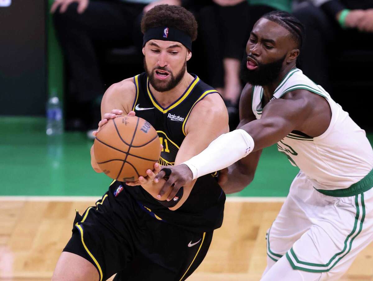 Golden State Warriors' Klay Thompson, 11, tries to get past Boston Celtics' Jaylen Brown, 7, during the second quarter of the NBA Finals at TD Garden in Boston, Mass., on Wednesday, June 8, 2022.