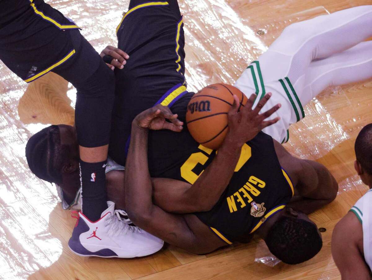 Golden State Warriors' Draymond Green, 23, and Boston Celtics' Jaylen Brown, 7, get tangled up during the third quarter of the NBA Finals at TD Garden in Boston, Mass., on Wednesday, June 8, 2022.