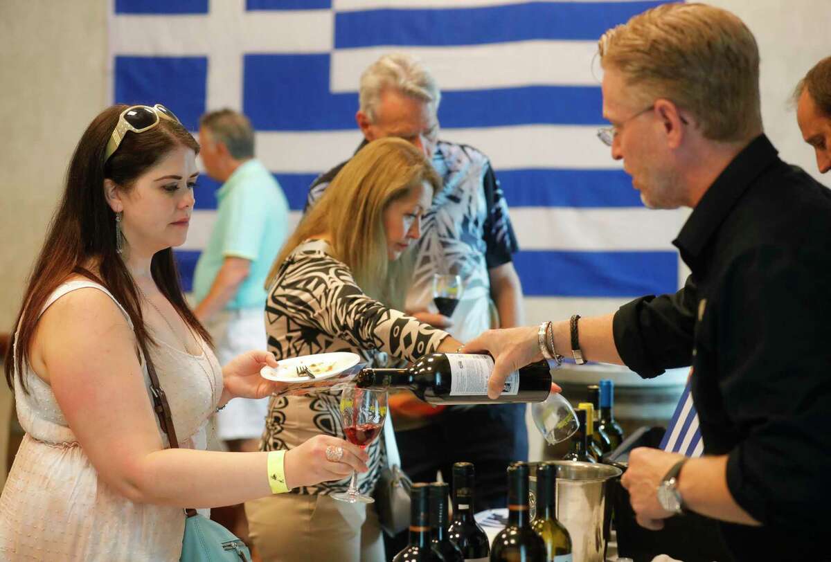 Lindsey Mangold gets a sample of red wine during Wine Around The World as part of Wine & Food Week, Wednesday, June 9, 2022, in The Woodlands.