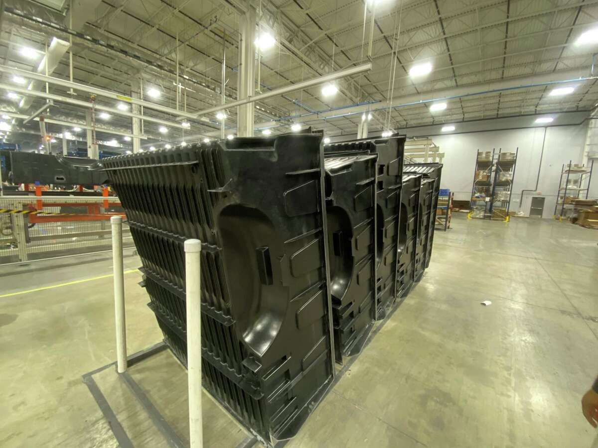 Truck beds sit ready for the next phase of assembly at Teijin Automotive Technologies’ new manufacturing plant in Seguin. Robotic arms place sheets of composite plastic into a three-story machine press that molds the plastic into pickup truck beds.