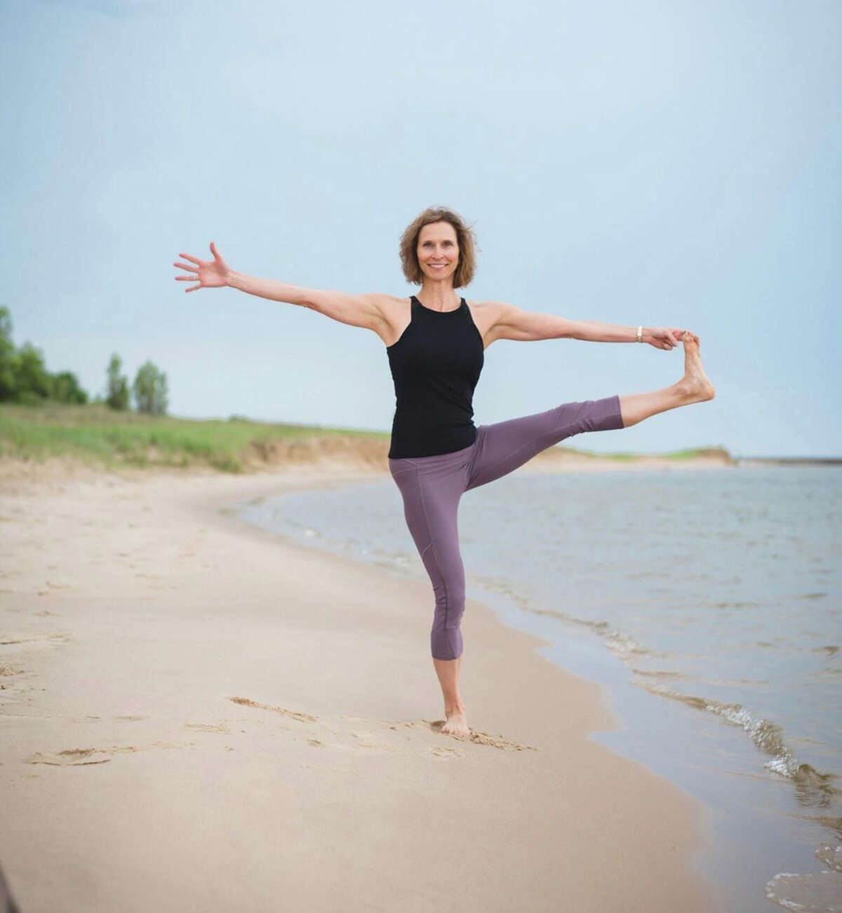 Mary Paine ishows that yoga can also be practiced outdoors during her beach classes.