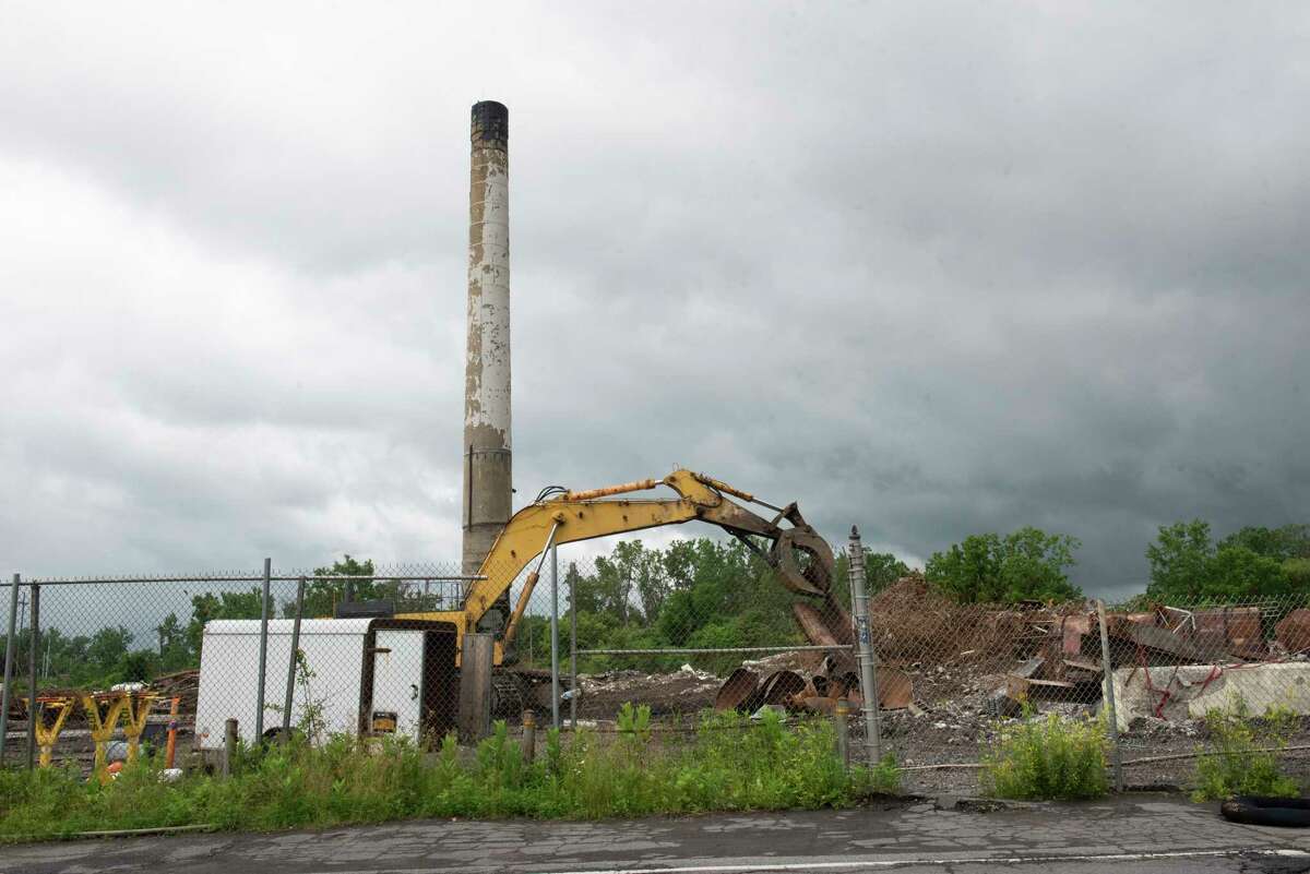 The smoke stack is the only standing structure left of the dilapidated First Prize factory on Thursday, June 9, 2022 in Colonie, N.Y. Demolition crews are working to clear the structure which has been an eye sore for many years.