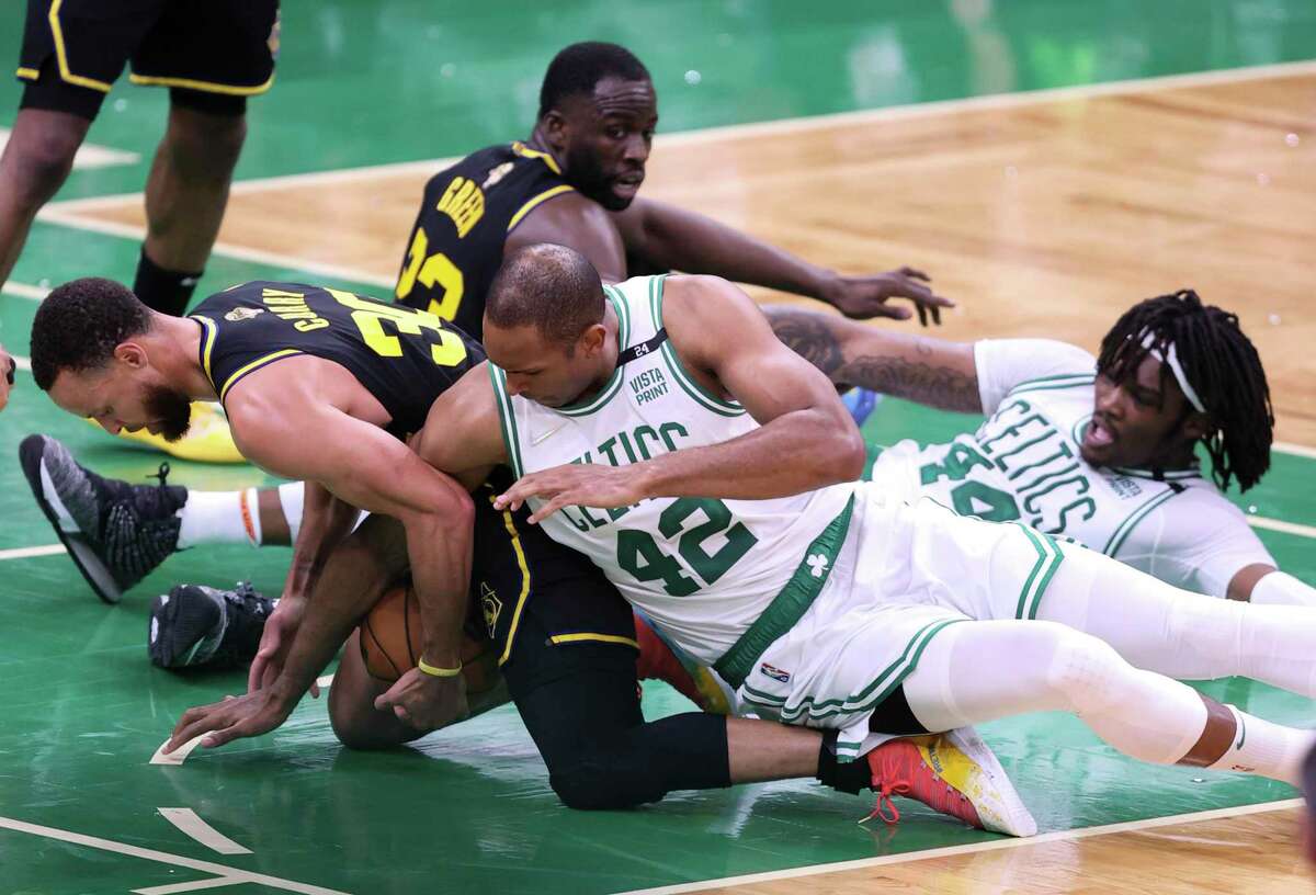 Golden State Warriors' Stephen Curry, 30, is caught under Boston Celtics' Al Horford, 42, during the fourth quarter of the NBA Finals at TD Garden in Boston, Mass., on Wednesday, June 8, 2022.