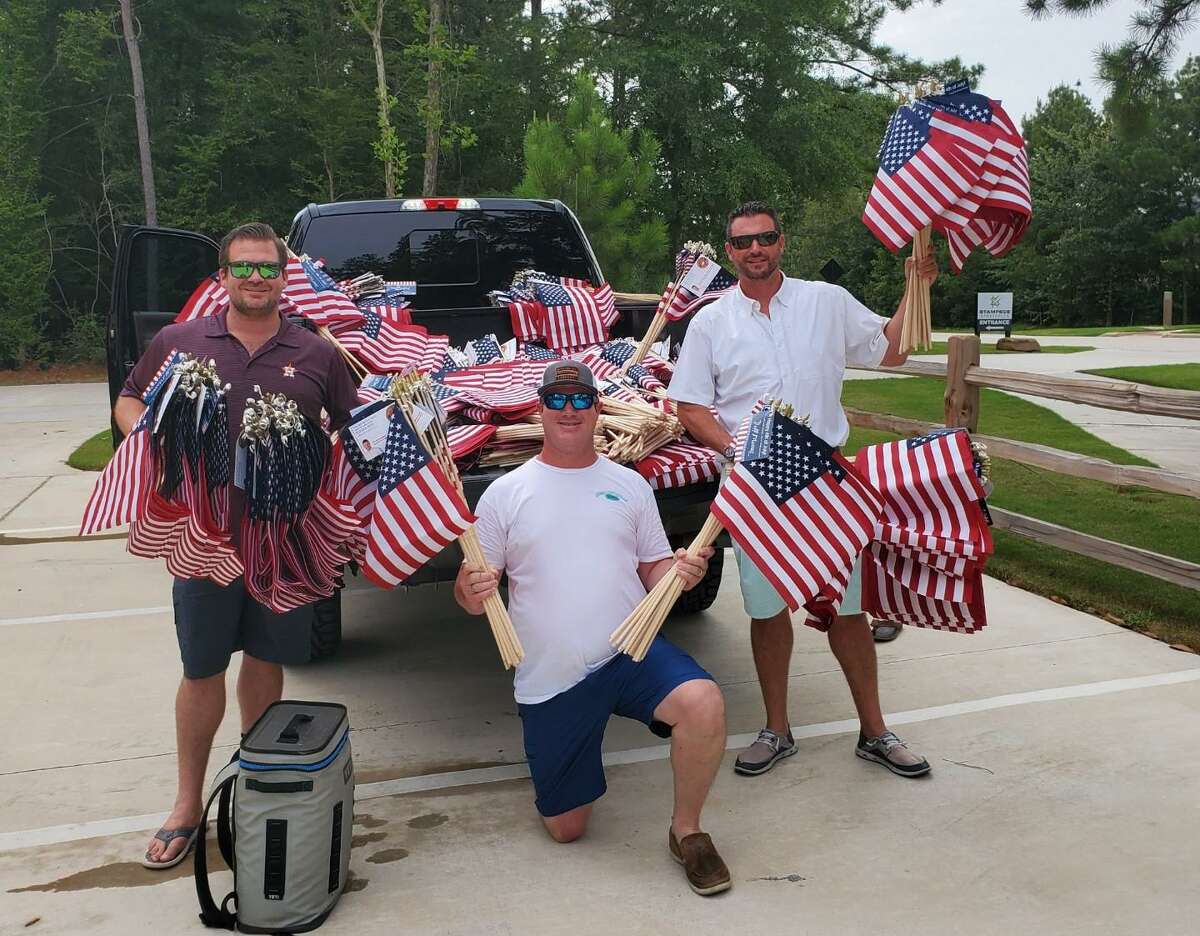 Jeff and Candice Morris and their seven children place 4,500 American flags at homes in the Woodforest community for the July 4 holiday. The also have a team of 20 volunteers who help with the effort.