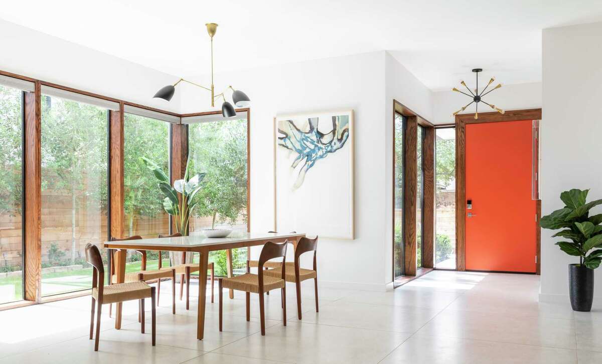 Big windows in the dining room provide a view of the lush outdoors. The artwork on the back wall is by longtime Glassell professor Arthur Turner, “Basalt Flyer,” watercolor, ink and graphite on paper.