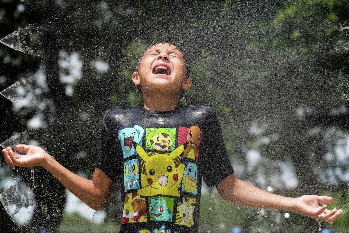 Mark Moreno takes advantage of the splash pad at Melrose Park to cool off Tuesday, May 31, 2022 in Houston. Temperatures in Houston hit the low 90s Tuesday, with highs forecast to the mid to high 90s through next week.