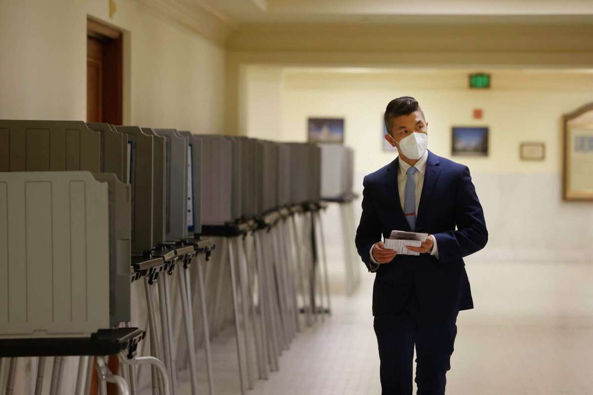 Binh Tran looks for a ballot drop box in an empty the poll location at San Francisco City Hall on Tuesday.