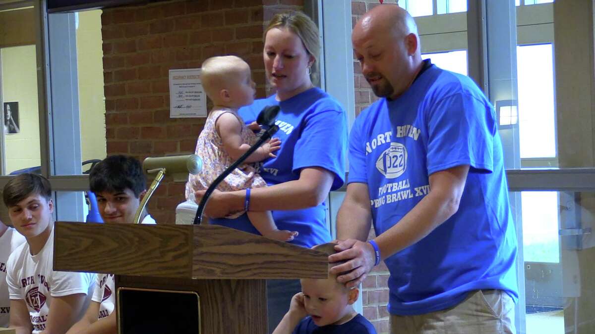 Honored guests Laura and Scott Gagne address the participants in the North Haven Spring Brawl draft at North Haven HS, Tuesday, May 31, 2022. Nate Gagne, 3, has cystic fibrosis and the June 10 game is being played to benefit his family.