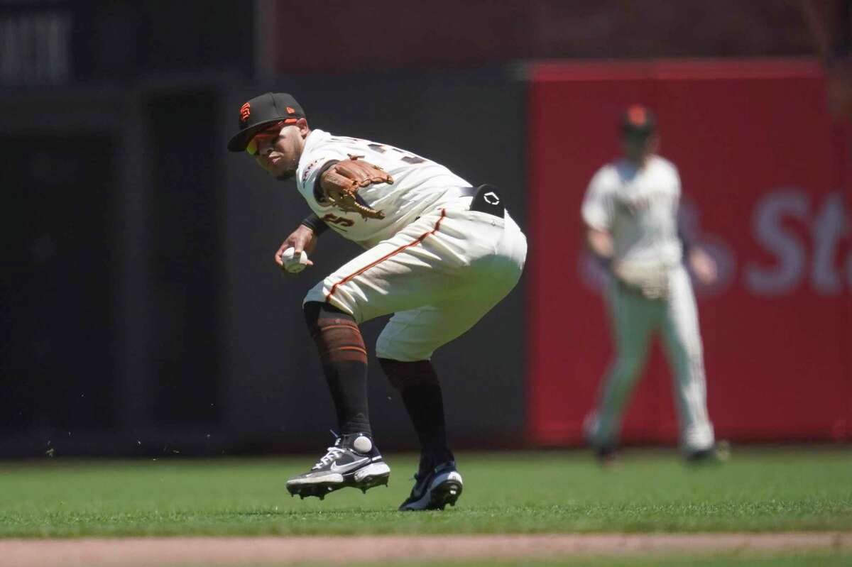 San Francisco Giants second baseman Thairo Estrada throws to first base after making a fielding error on a ground ball hit by Colorado Rockies' Charlie Blackmon during the fourth inning of a baseball game in San Francisco, Thursday, June 9, 2022. (AP Photo/Jeff Chiu)