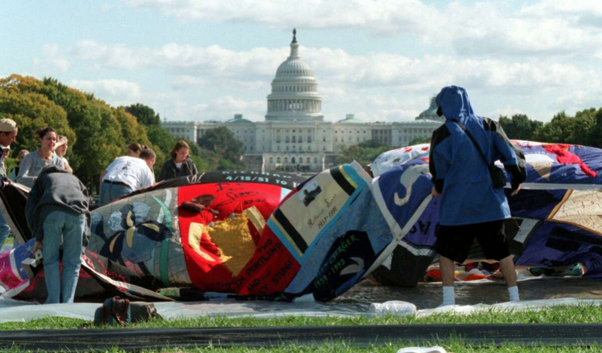 Volunteers prepare the AIDS Memorial Quilt on the Mall in Washington in 1996.