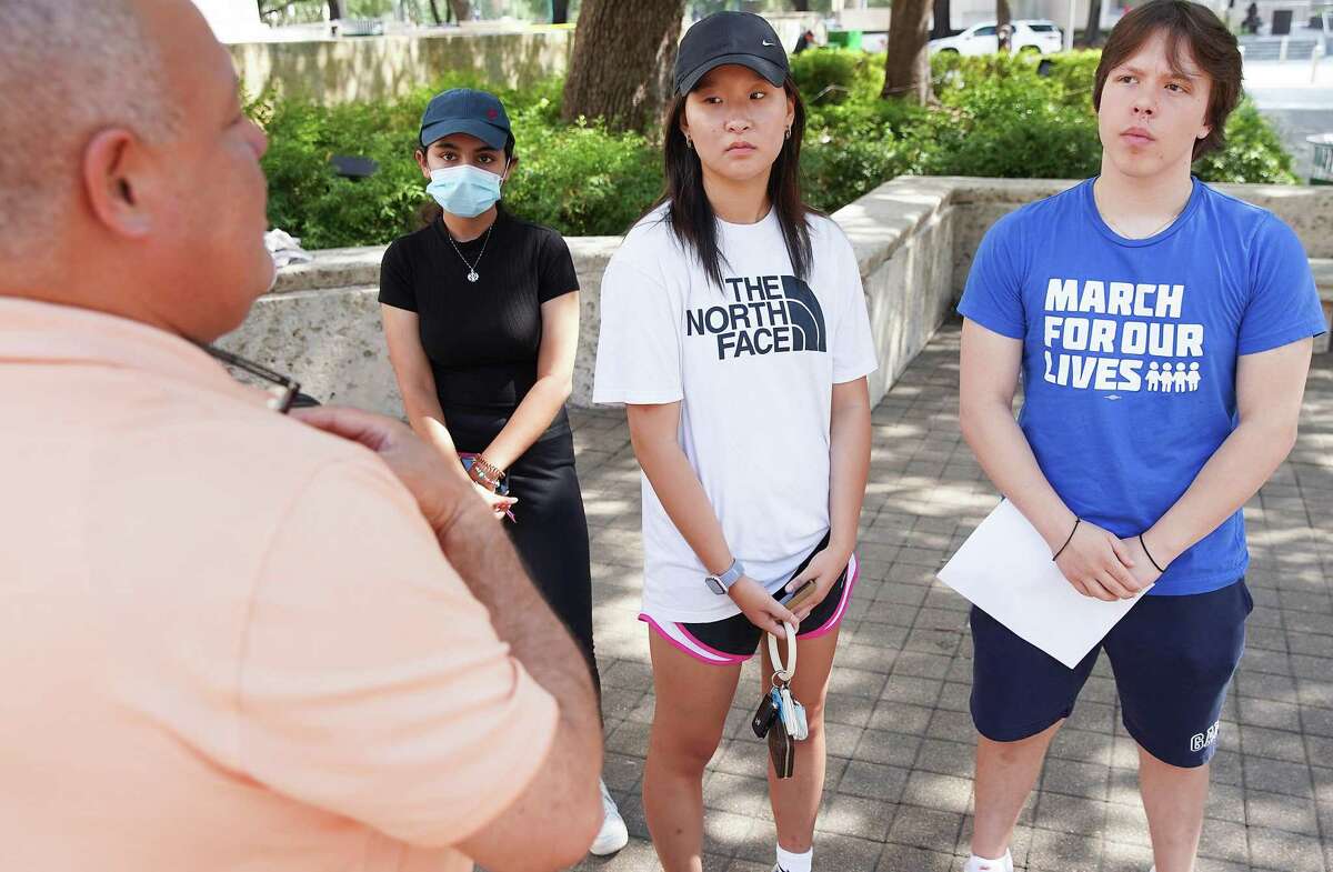 Houston chapter of March for Our Lives members Manasi Saxena, from left, Katherine Chen and George Tataris listen to Sgt. Raul Cruz of HPD, on Thursday, June 9, 2022 as they plan for a rally to be held at Houston City Hall on Saturday.