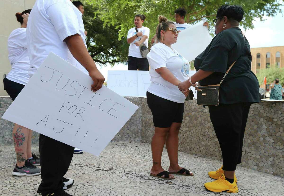 Lynda Espinoza (center) gets words of comfort from Debbie Bush - the aunt of Marquis Jones who was shot and killed by police in 2015 - as they gather with local activists to decry the shooting of Espinoza's 13-year-old son, A.J. Hernandez, by an officer after reportedly T-boning a police car last week. The group gathered at Public Safety Headquarters to demand answers surrounding the boy's death.